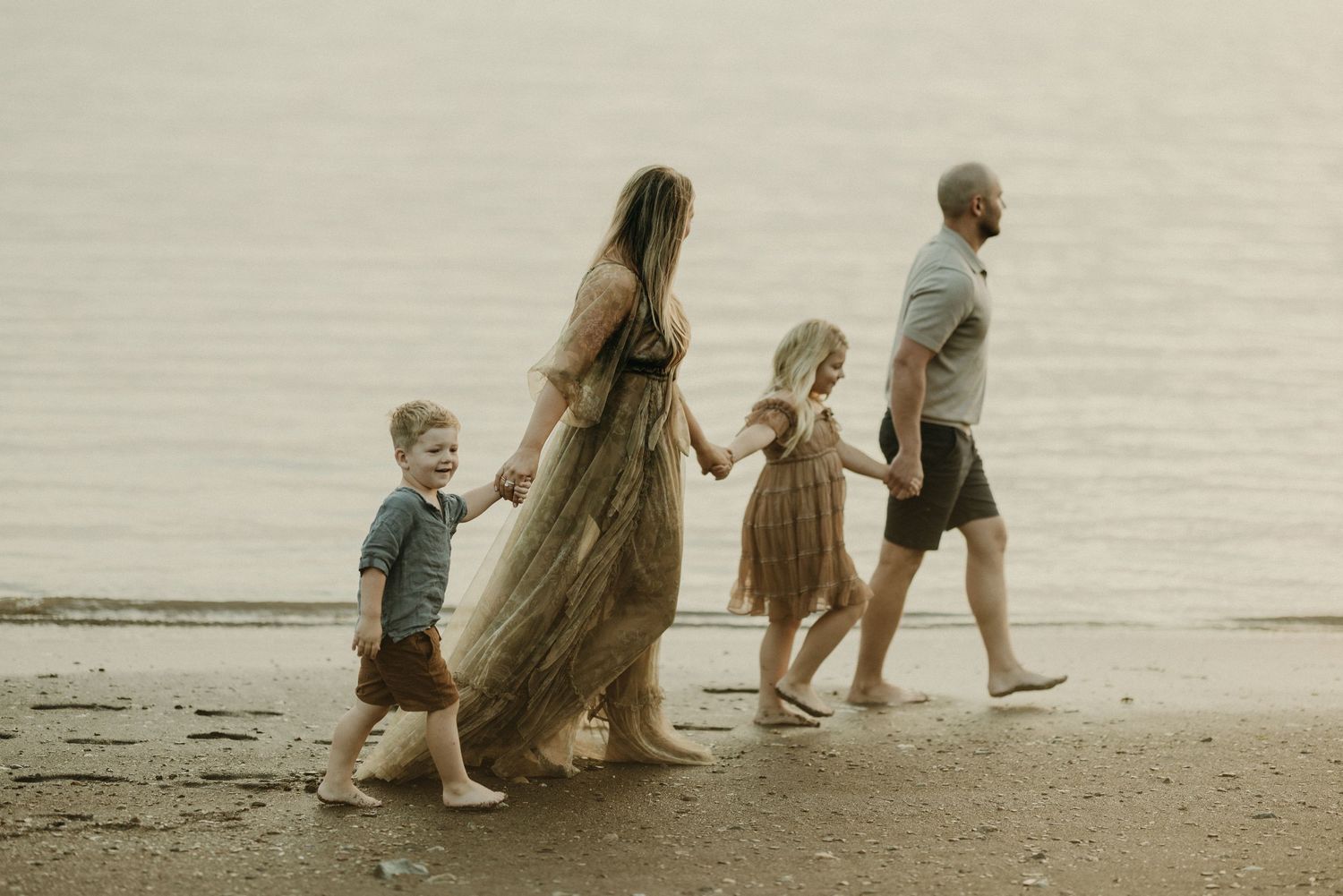 A group enjoys a peaceful evening by the ocean during golden hour.