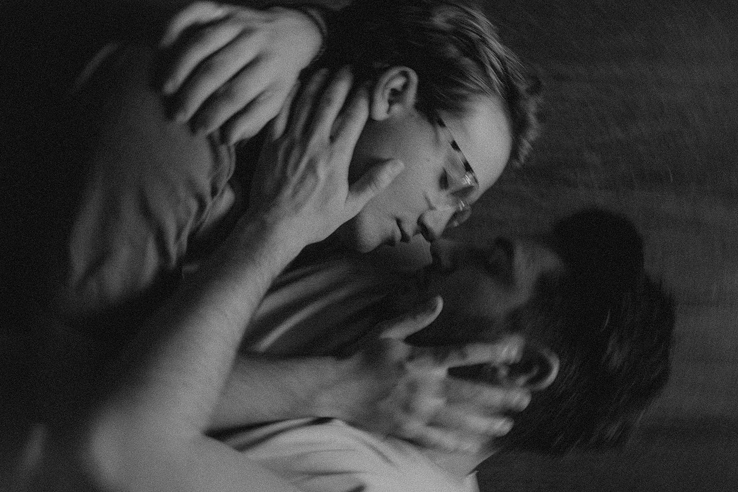 Black and white photo montage showing seven intimate emotional moments between couples in dark lighting.