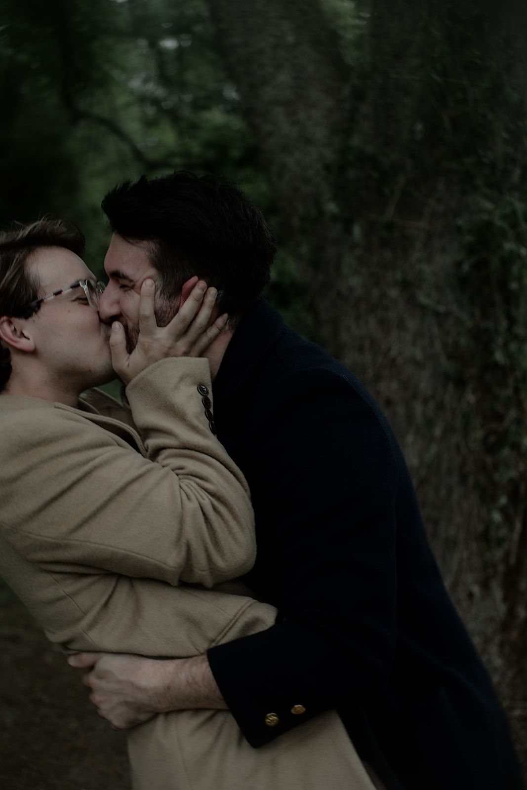 Two figures embracing in a romantic scene against a dark forest backdrop.