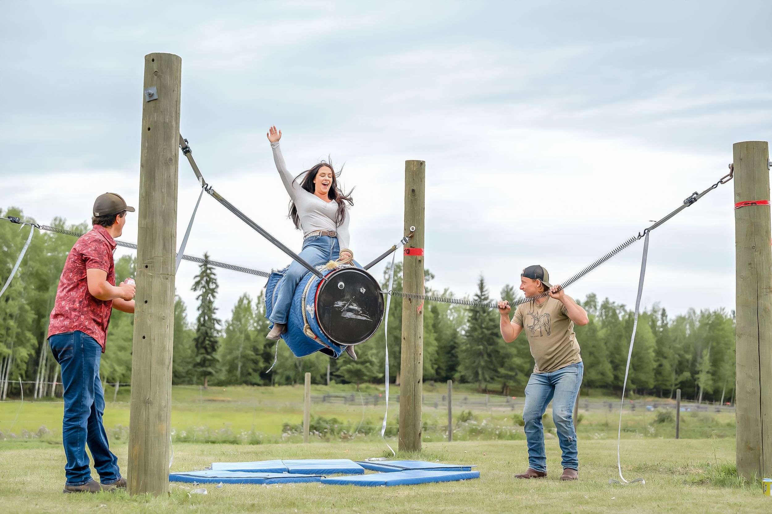 Children enjoy playing on a backyard zipline course during outdoor recreational activities in a grassy field.