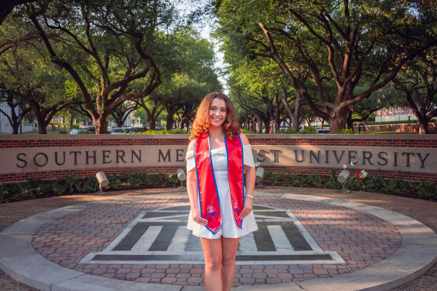 Outdoor graduation photos taken at a university campus with brick pathways and trees.