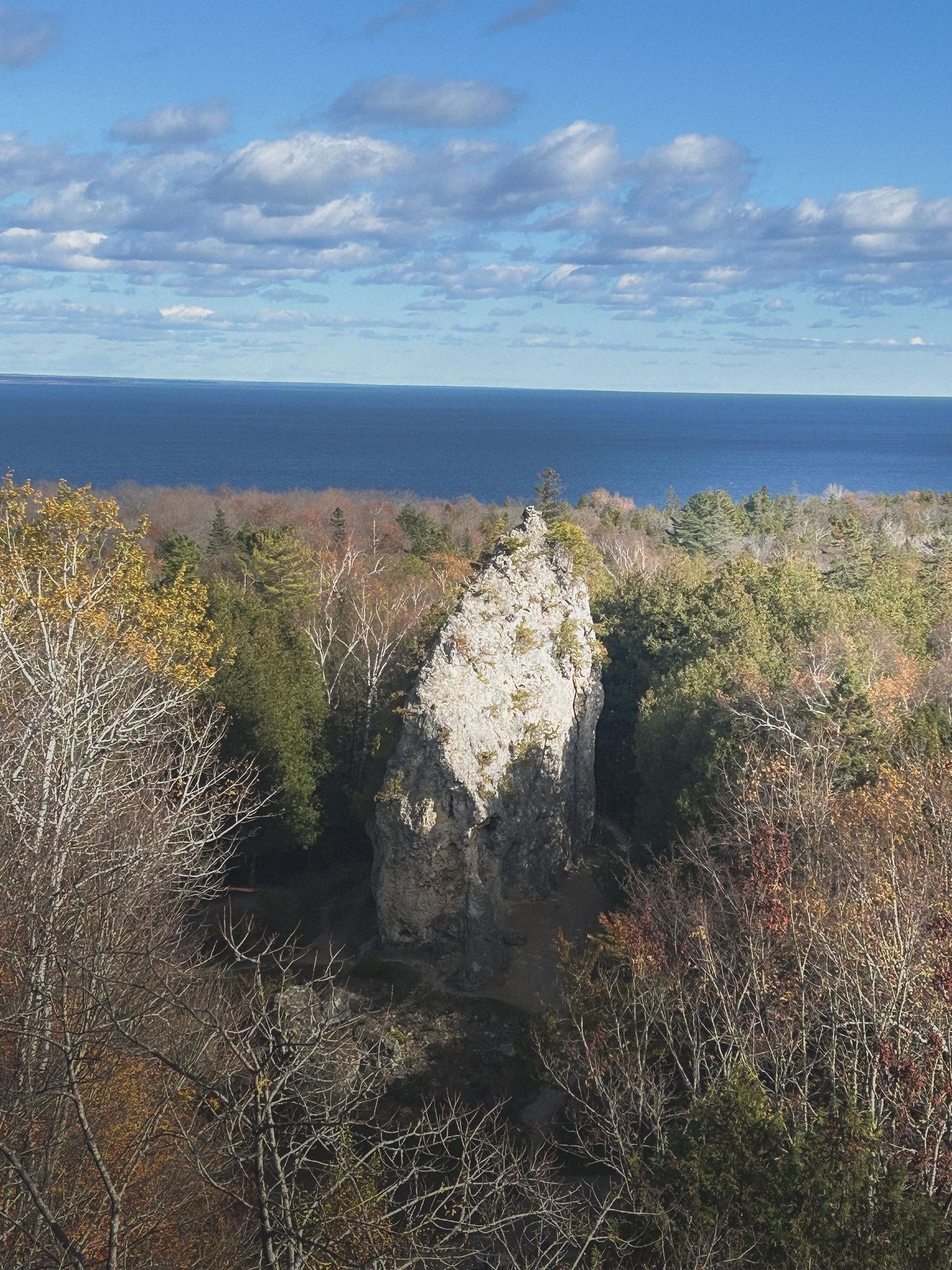 Dramatic waterfall cascading down sandstone cliffs in a lush forest setting.