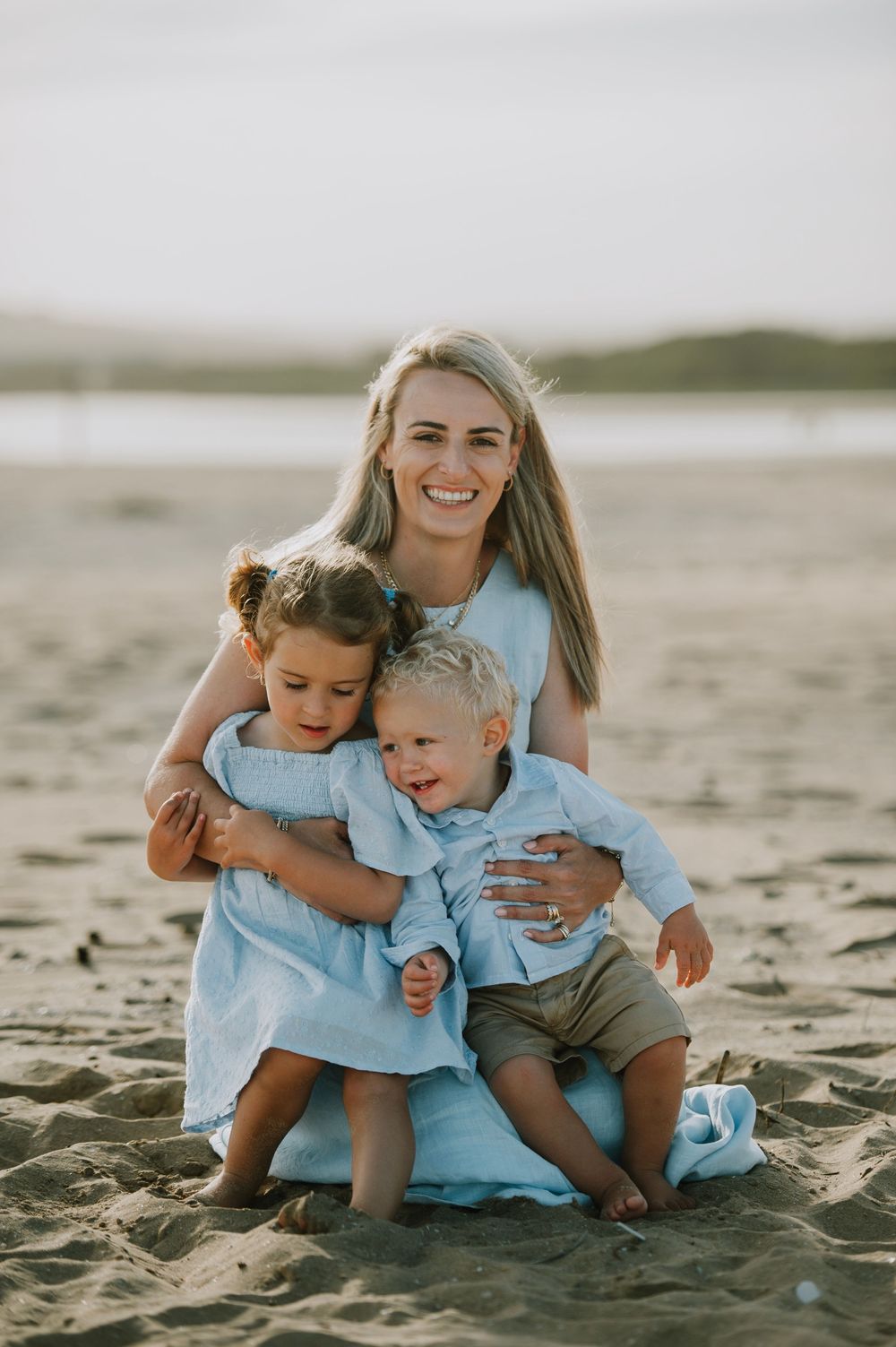 Mom Holding her daughter and son on Hartenbos beach