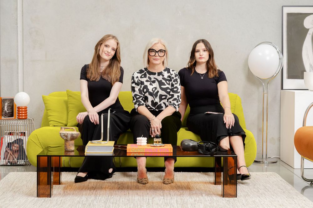 Your Hive team photos, group posed sitting on a modern green couch.