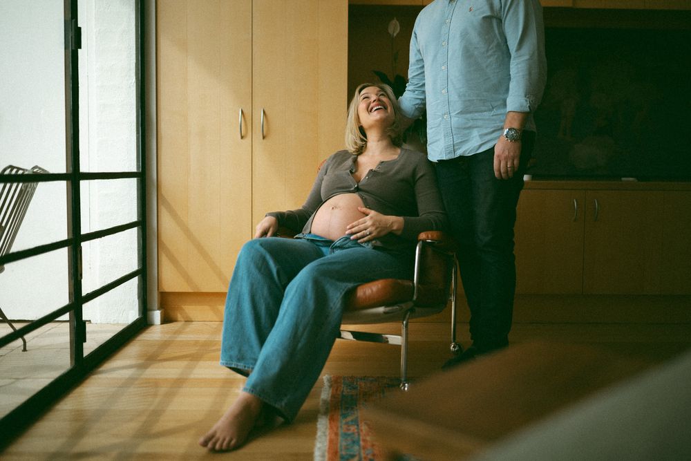 Person in casual clothing sits by large window in series of connected contemplative poses.