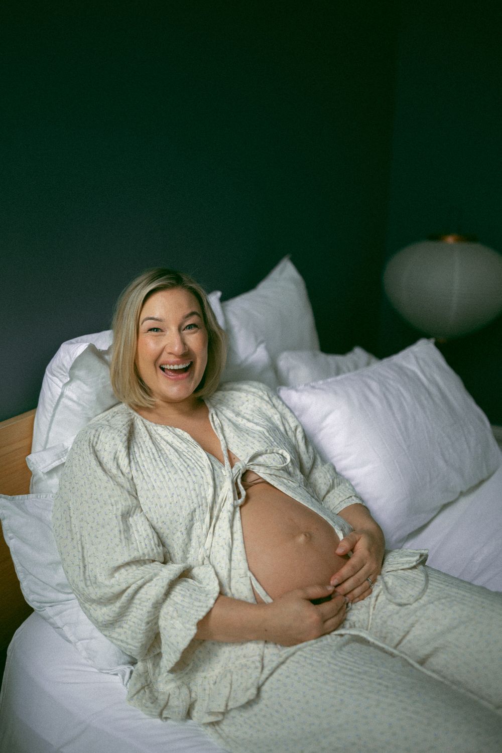 A series of photos showing someone relaxing on a white bed wearing a cozy cream-colored sweater.