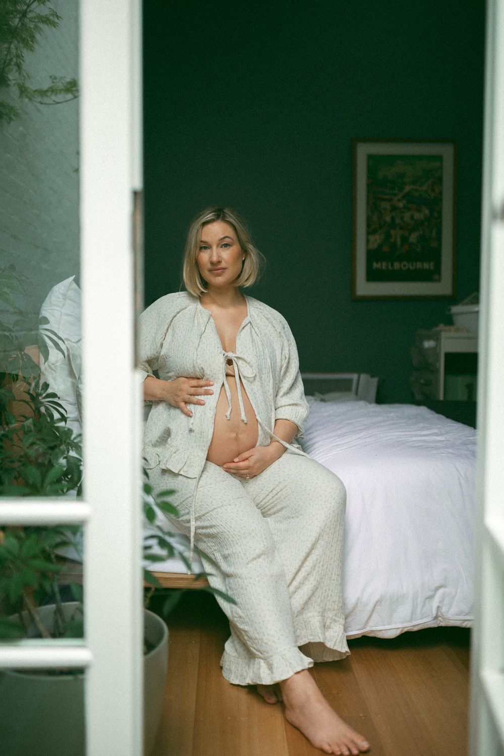 A series of artistic photographs showing someone in white clothing sitting on a bed near windows with natural light.