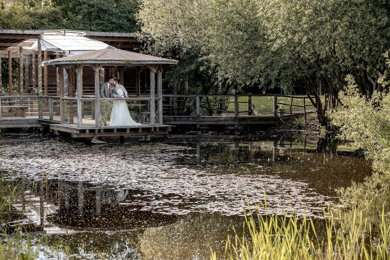 A relaxed guided couples wedding portrait by a lake.