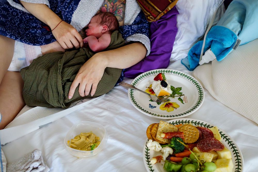 People sharing a meal together at a table with multiple plates of colorful food and garnishes.