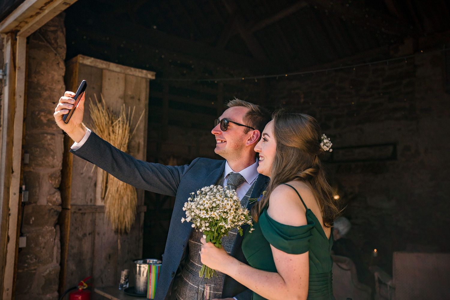 Wedding couple taking a selfie together in a rustic barn setting at Healy Events wedding venue.