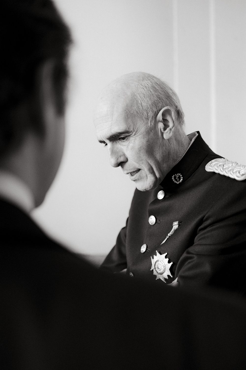 High-ranking military officer in uniform with medals shown in black and white profile portrait.