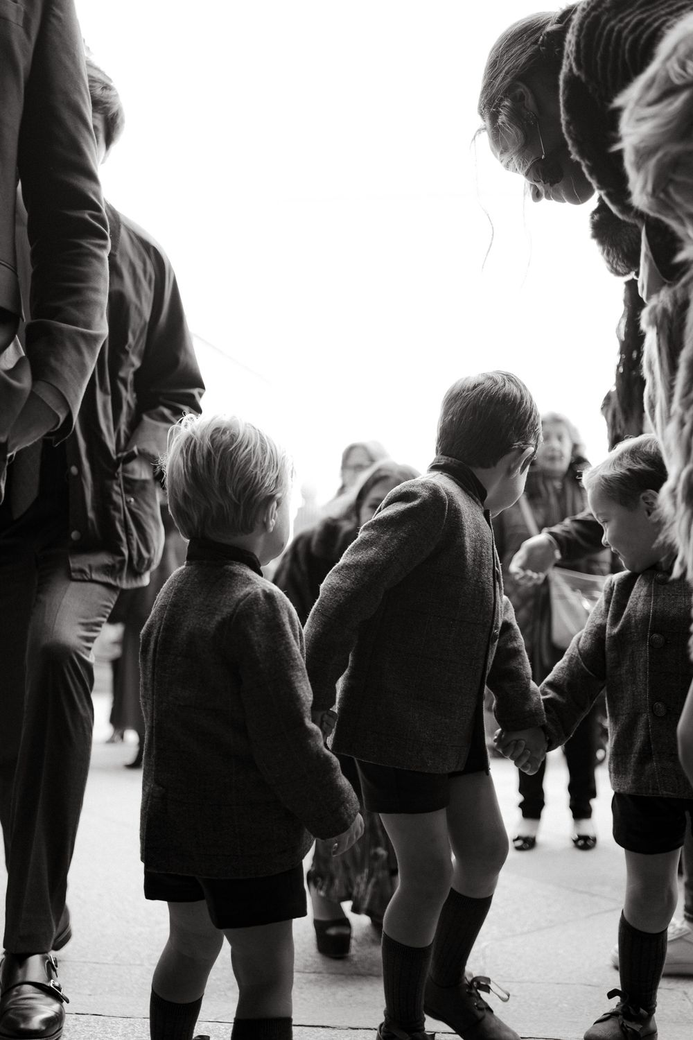 Black and white image of children and adults gathered in a group.