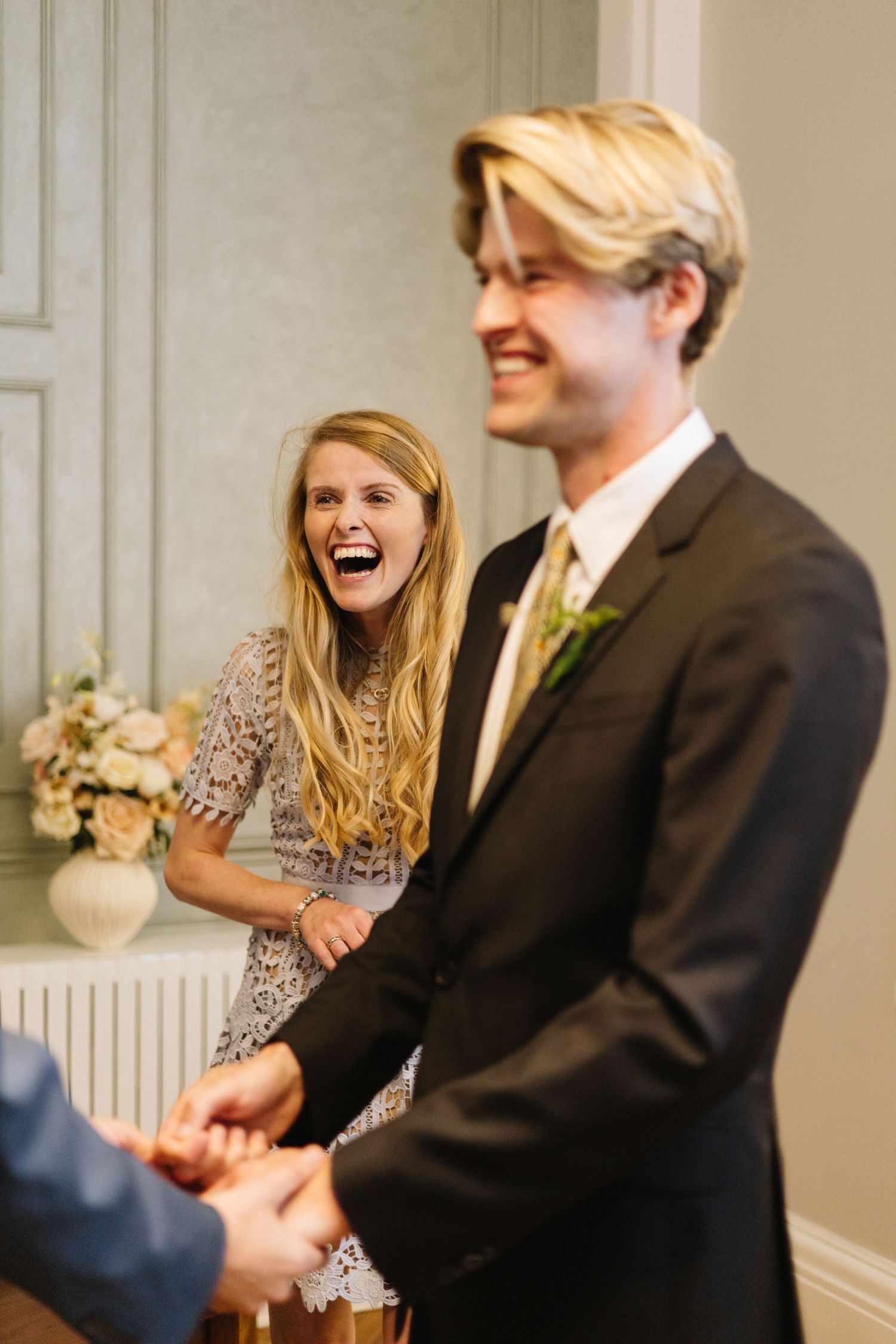 A joyful moment of laughter during a formal gathering.