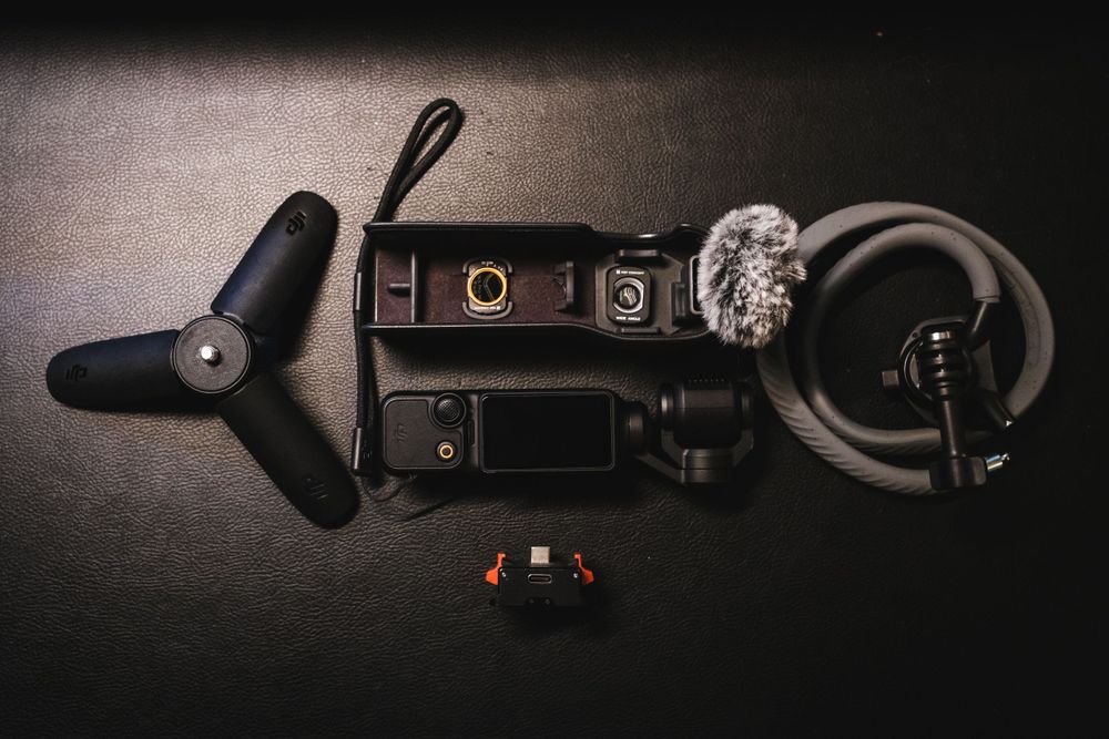 DJI Osmo pocket 3 with accessories on a black leather background