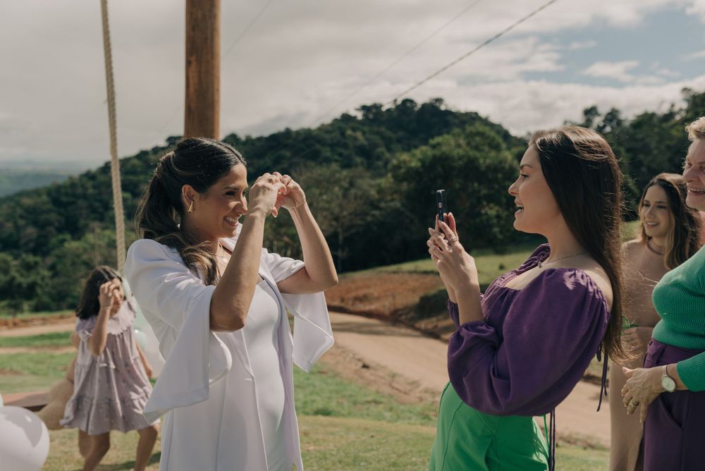 Two friends sharing a joyful moment outdoors with mountains in the background.