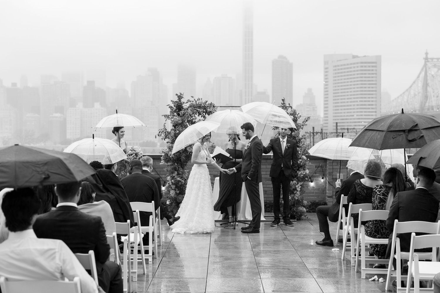 A luxurious wedding venue featuring a copper-toned ceiling installation with dramatic lighting and floral arrangements.