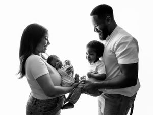 A series of black and white photos showing parents feeding and caring for their babies.