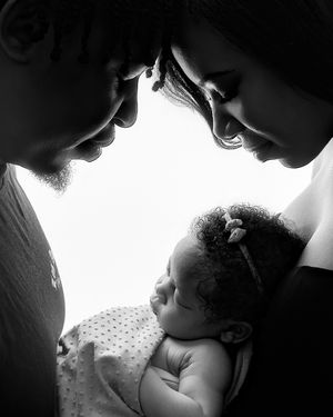 Black and white intimate photos capturing tender moments between parent and infant in silhouette.