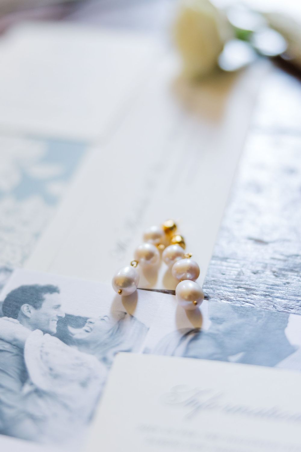 Small decorative pearl figures arranged on a black and white photograph representing a nostalgic moment.