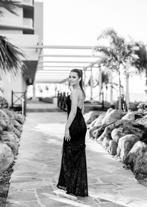 Black and white portrait series along stone-lined walkway with architectural elements.