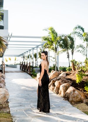 Elegant photography session on stone pathway with tropical landscaping.