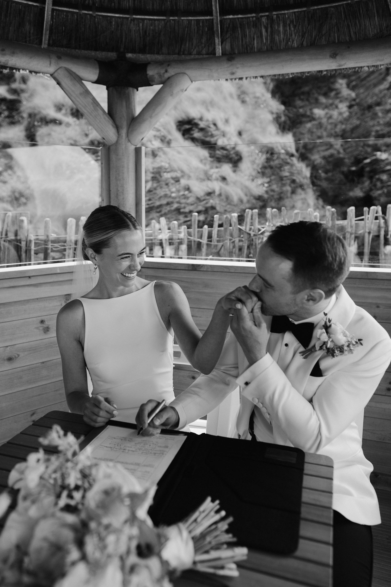 bride and groom signing wedding certificate at tunnels beach wedding venue