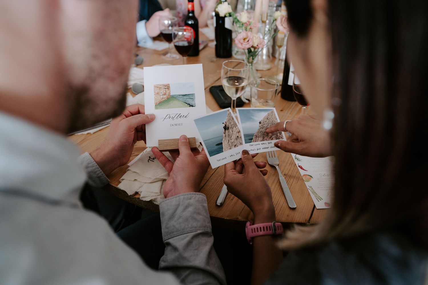 wedding guests looking at stationary at tunnels beach wedding venue in north devon