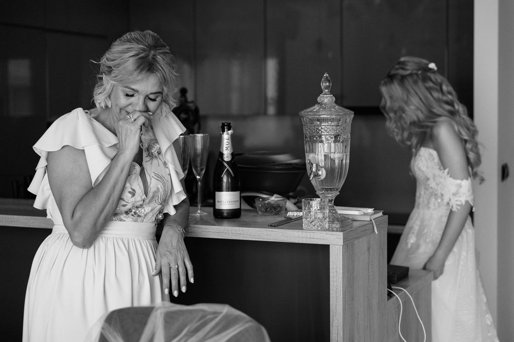 A sequence of black and white photos showing emotional reactions during a wedding celebration.