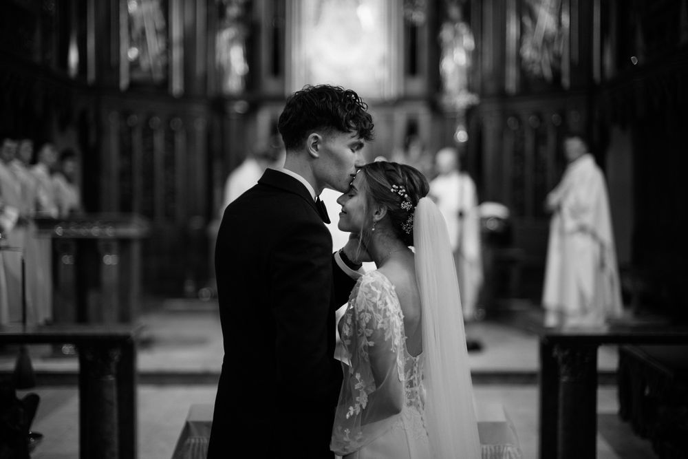 A black and white collage of wedding moments showing couples in romantic poses and elegant attire.