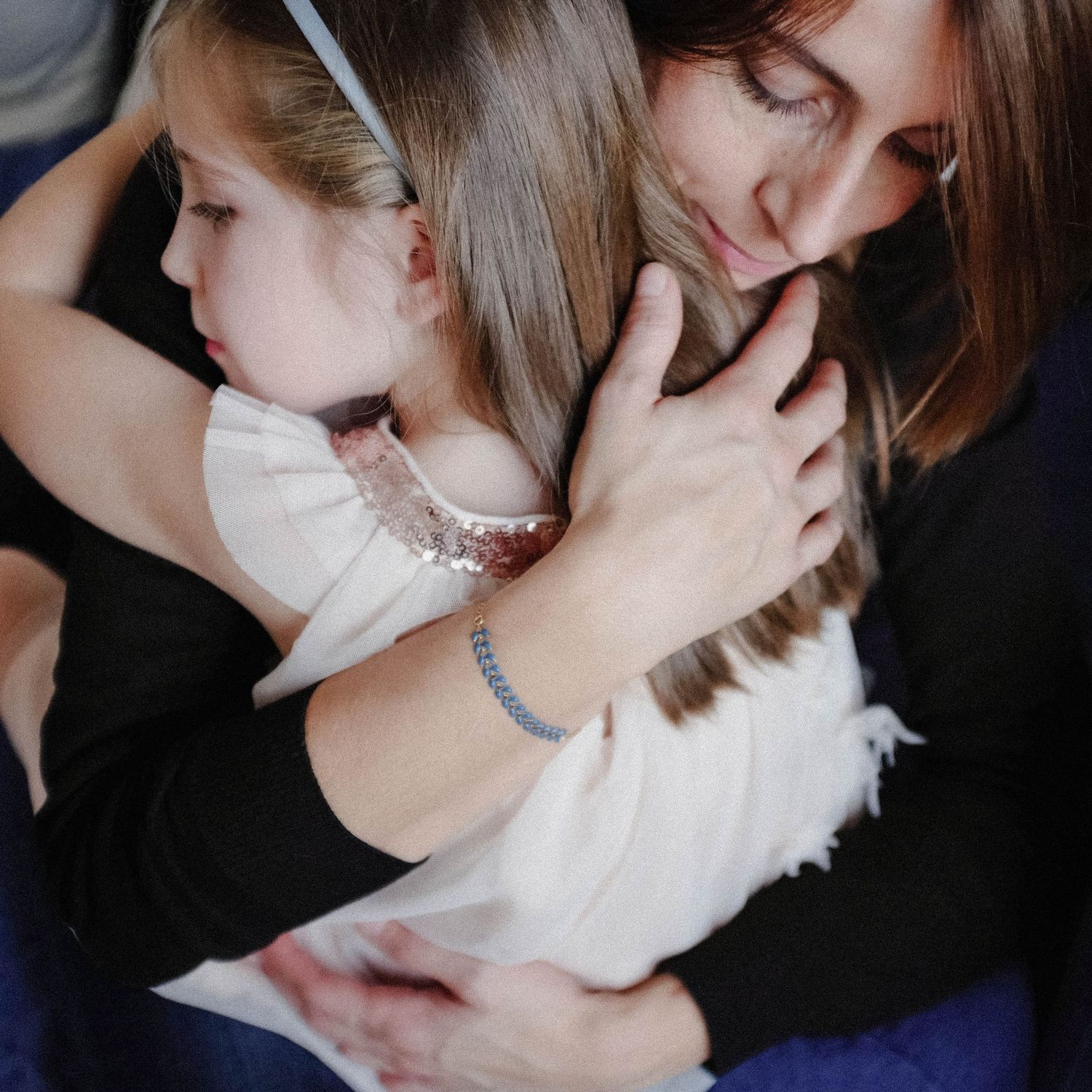 Two people sharing tender moment in close embrace with soft lighting.
