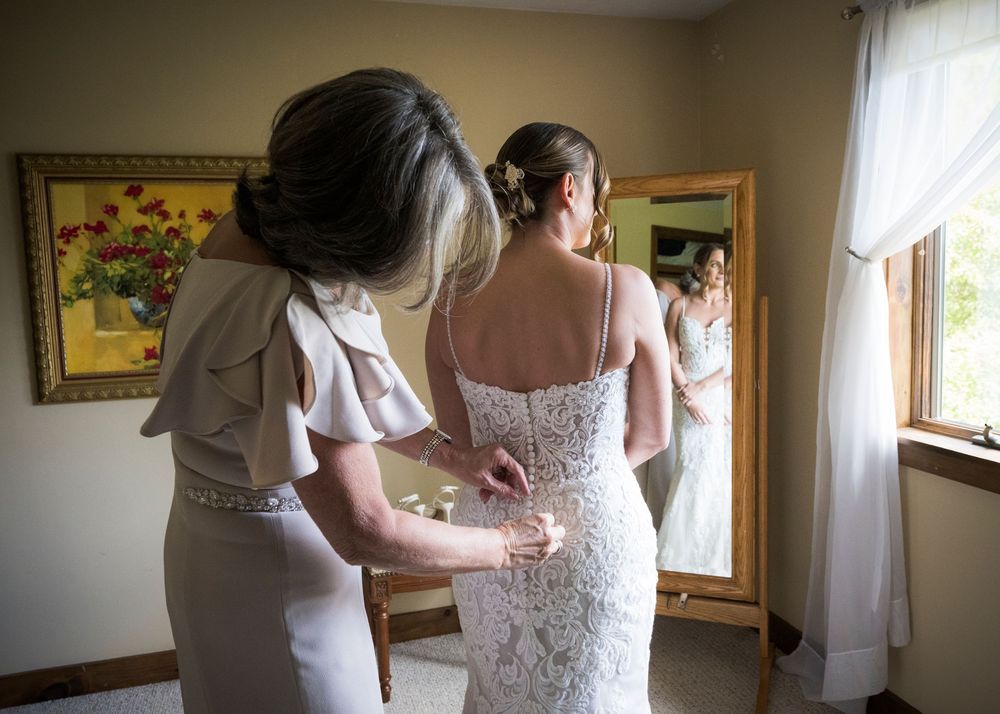 A sequence of wedding dress preparation moments showing delicate lace details and final adjustments in a sunlit room.