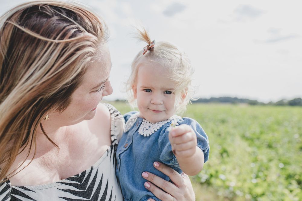 Intimate moment between parent and child against a bright outdoor backdrop.
Suffolk Family photos. Beckie Egan Photography.
