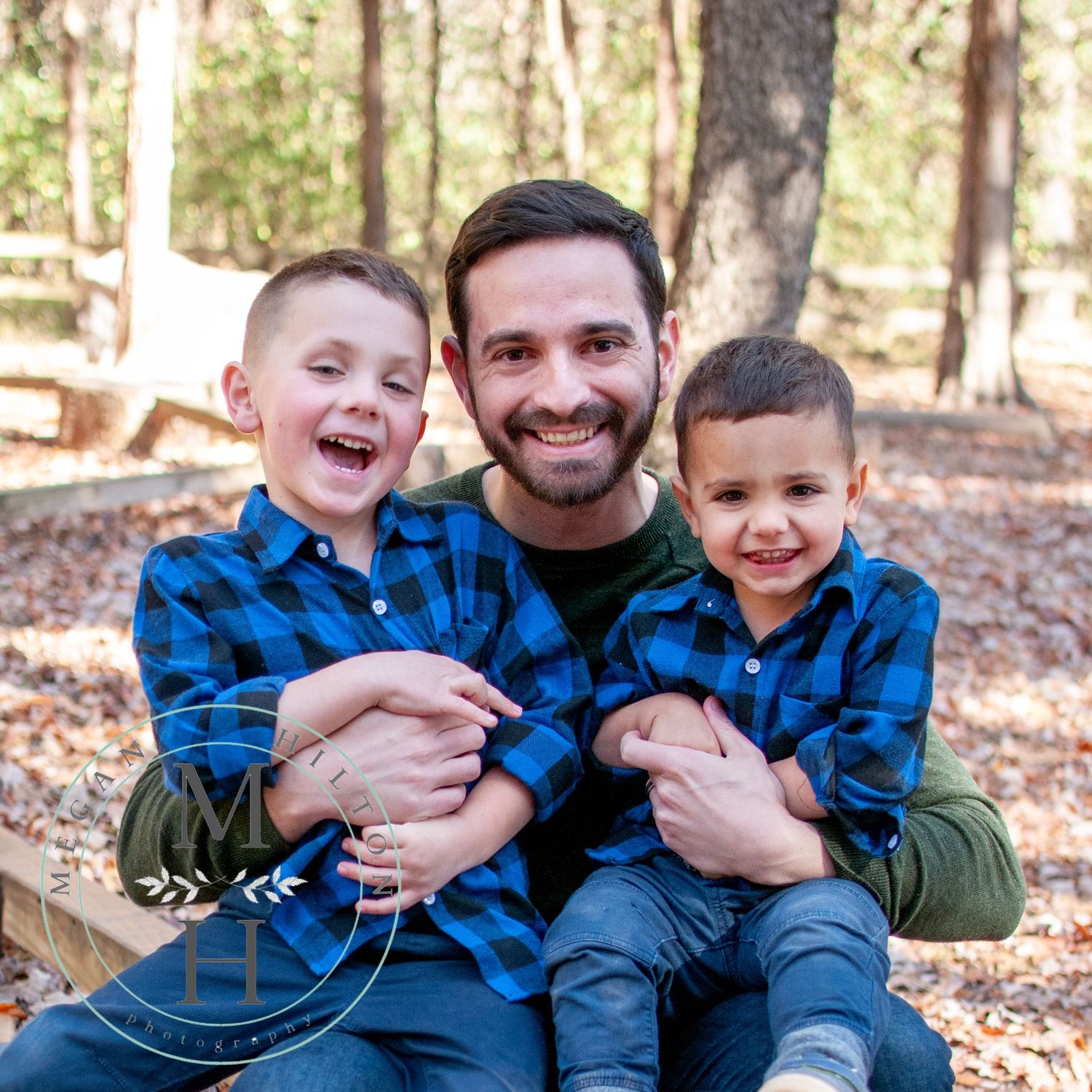 Dad and two young boys smiling photo