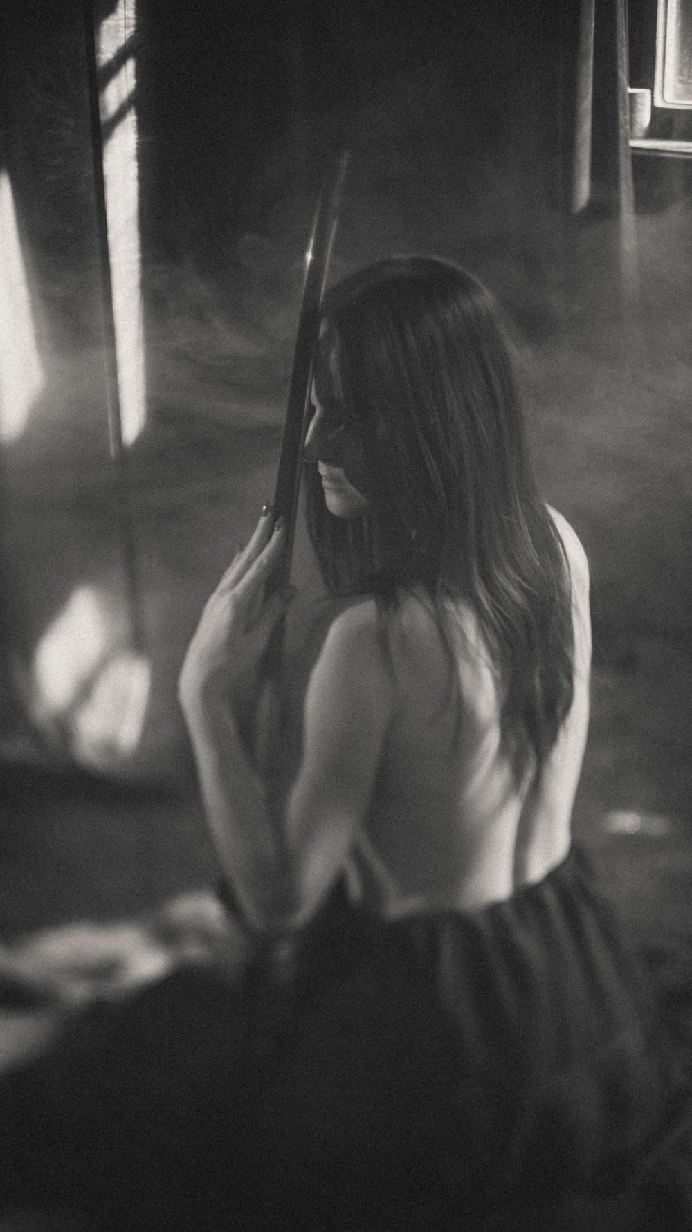 Artistic black and white silhouette photo with dramatic shadows and lighting.