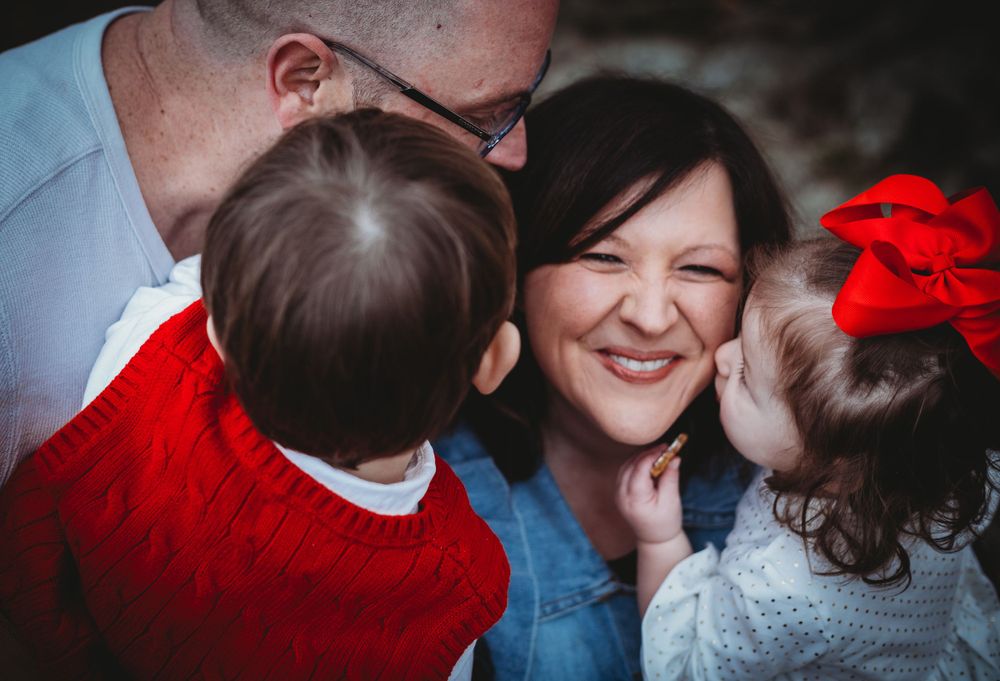 Happy family sharing a tender moment together with festive red accents.