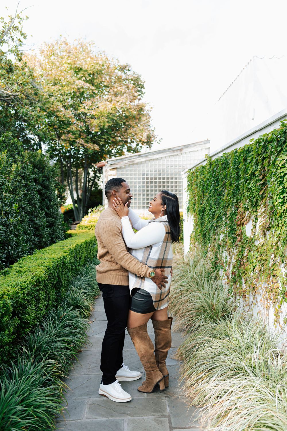 Playful couple posing in casual outfits at the Arboretum