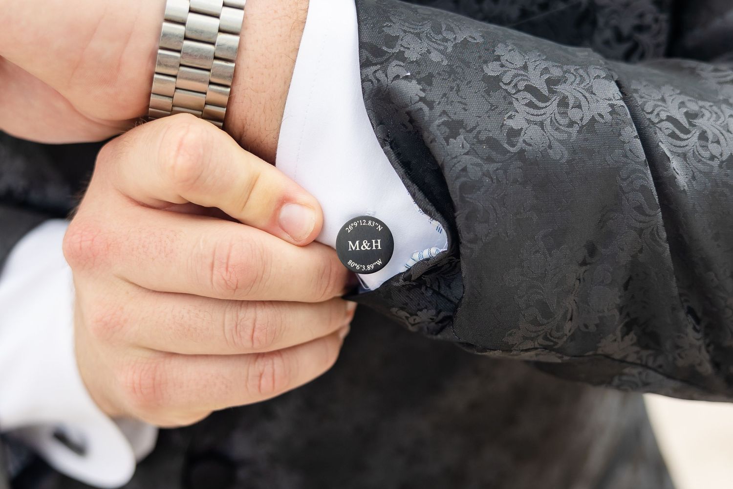 Close-up view of a hand checking tire pressure with a gauge on a motorcycle wheel.