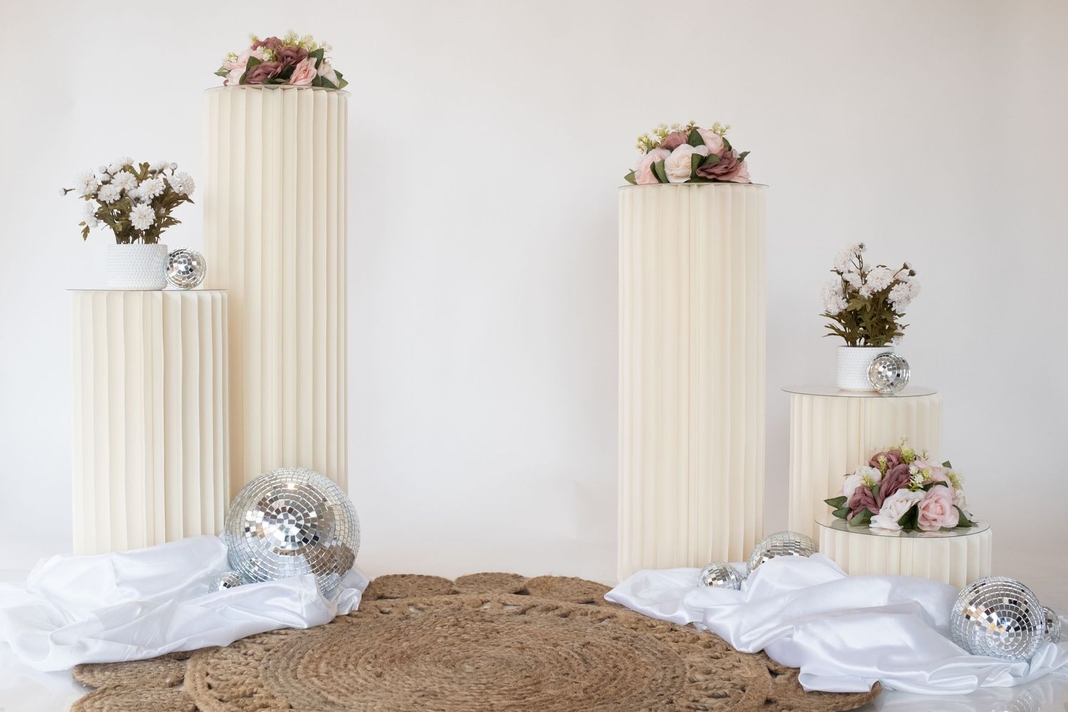 White fluted columns decorated with flowers and disco balls create an elegant display setting. Perth WA Photo booth Hire Event Booth