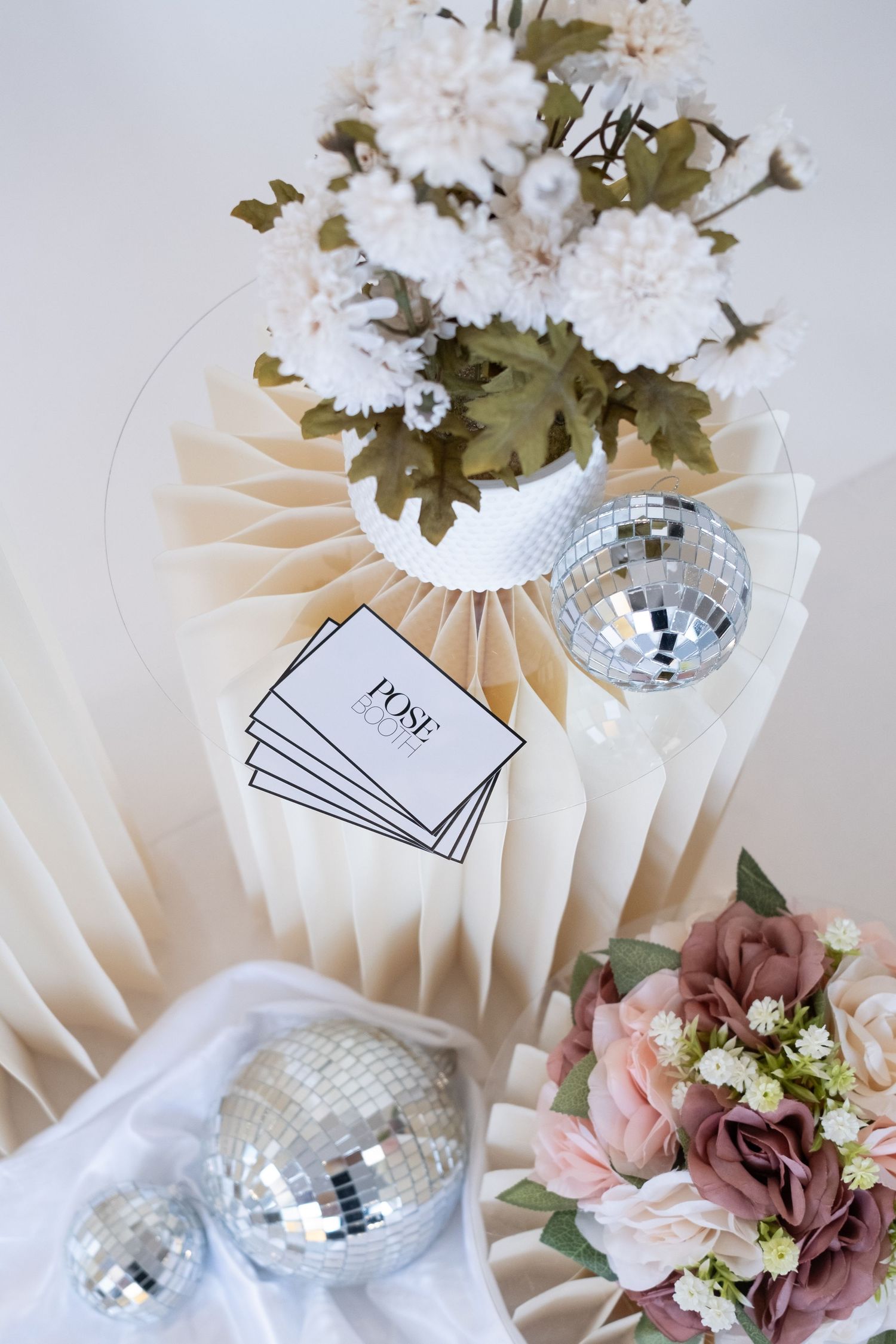 Decorative white pedestal with silver disco balls and romantic floral arrangements in soft pink. Perth WA Photo booth Hire Event Booth