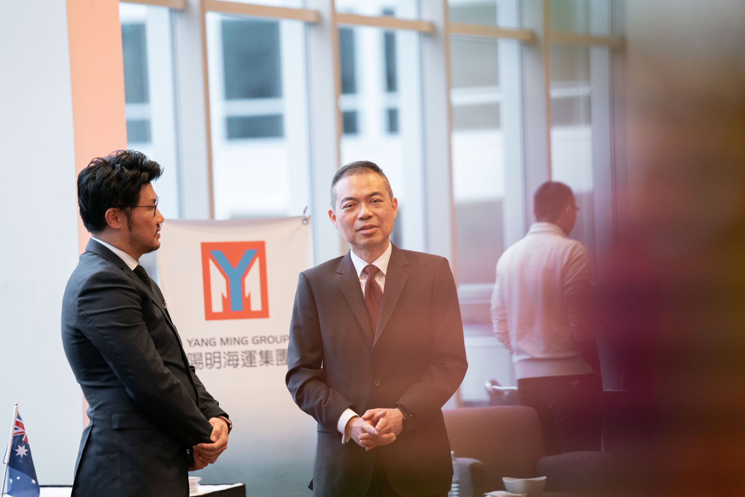 Business professionals engage in conversation at networking event.