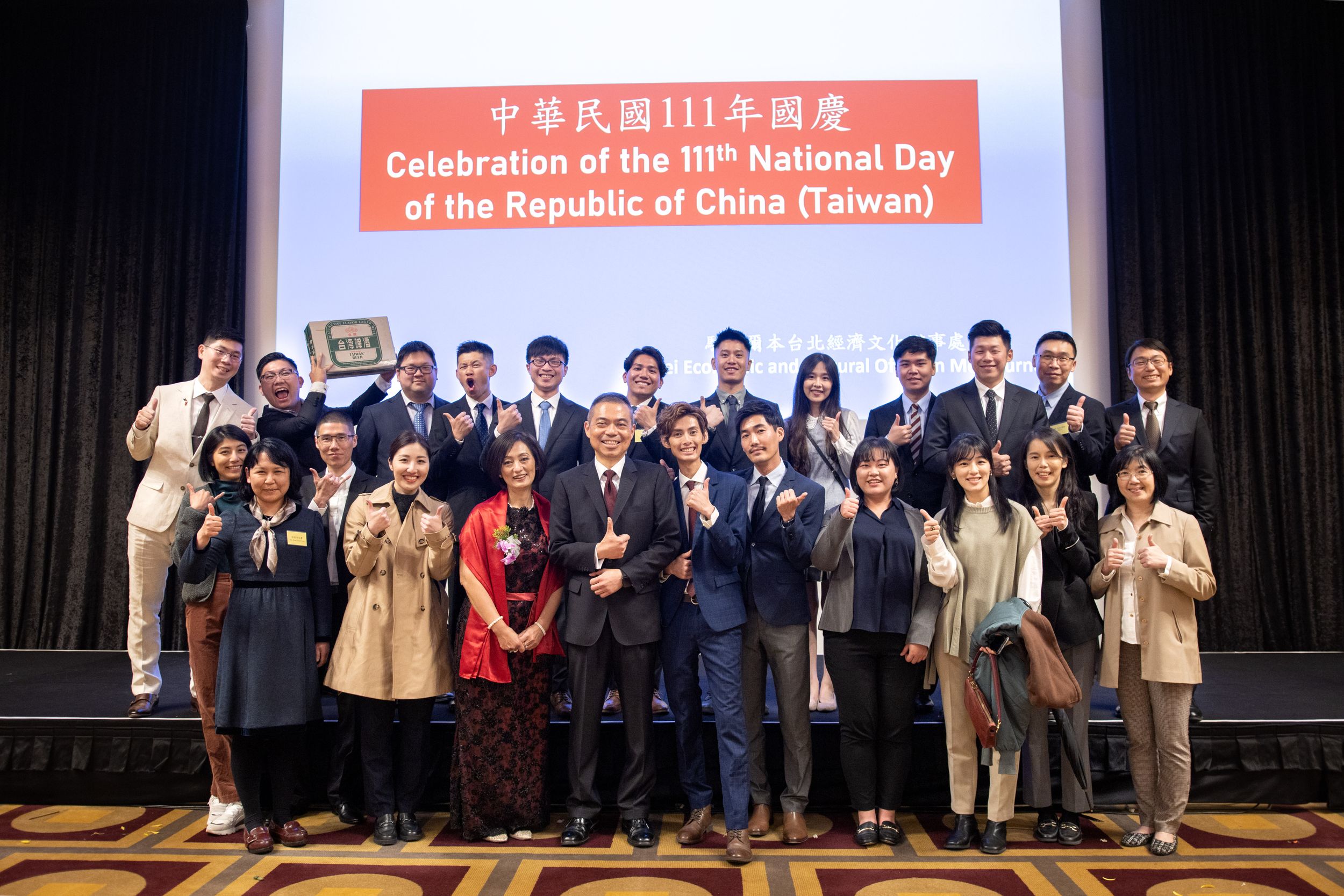 Large group poses for photo at Taiwan National Day celebration event.