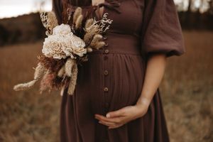 A romantic autumn wedding scene with bridesmaids in burgundy dresses holding bouquets in a rustic outdoor setting.