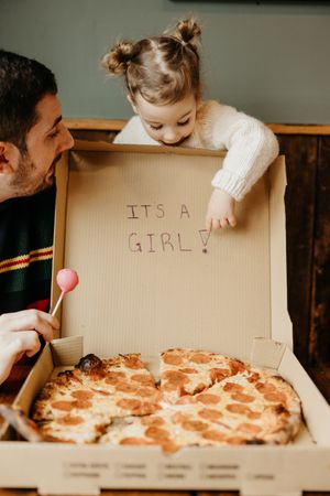 A sequence of photos showing someone opening a pizza box to reveal a message written inside the lid.