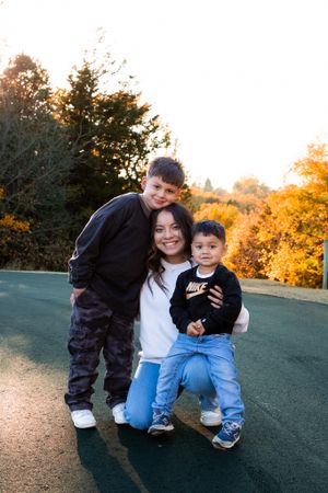 Young mother and two sons gathered for family photos at Cottonmill Park, Kearney, NE.
