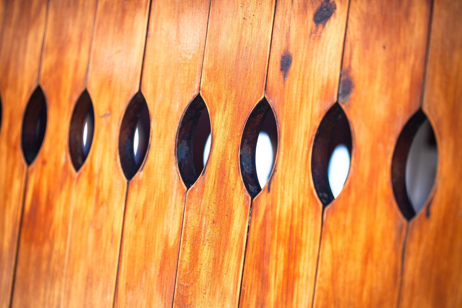 Abstract wooden screen with holes. Photographed in Torrox Costa, Andalucia, Spain.