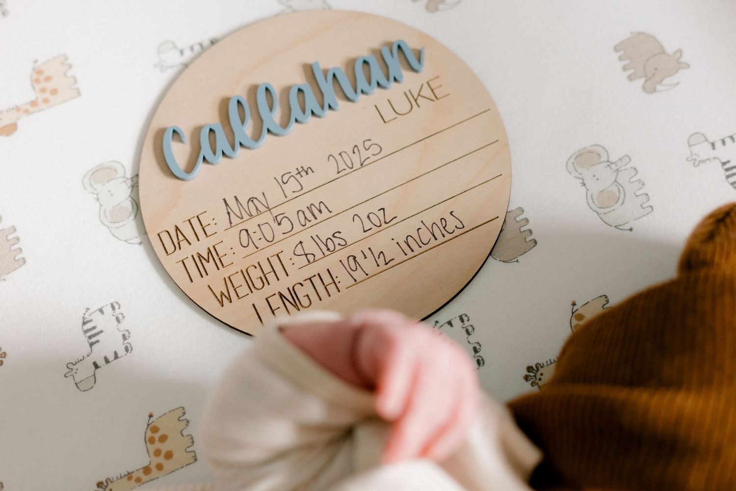 Wooden birth announcement disc for baby Callahan Luke with date, time, weight, and length details.