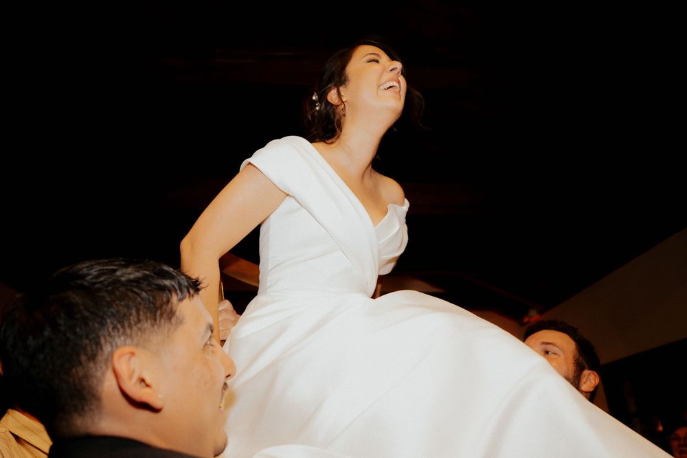 Wedding celebration dance sequence showing joyful movement and spinning on a dark dance floor.