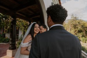 Elegant wedding ceremony set against a mountain backdrop with palm trees and tropical foliage.