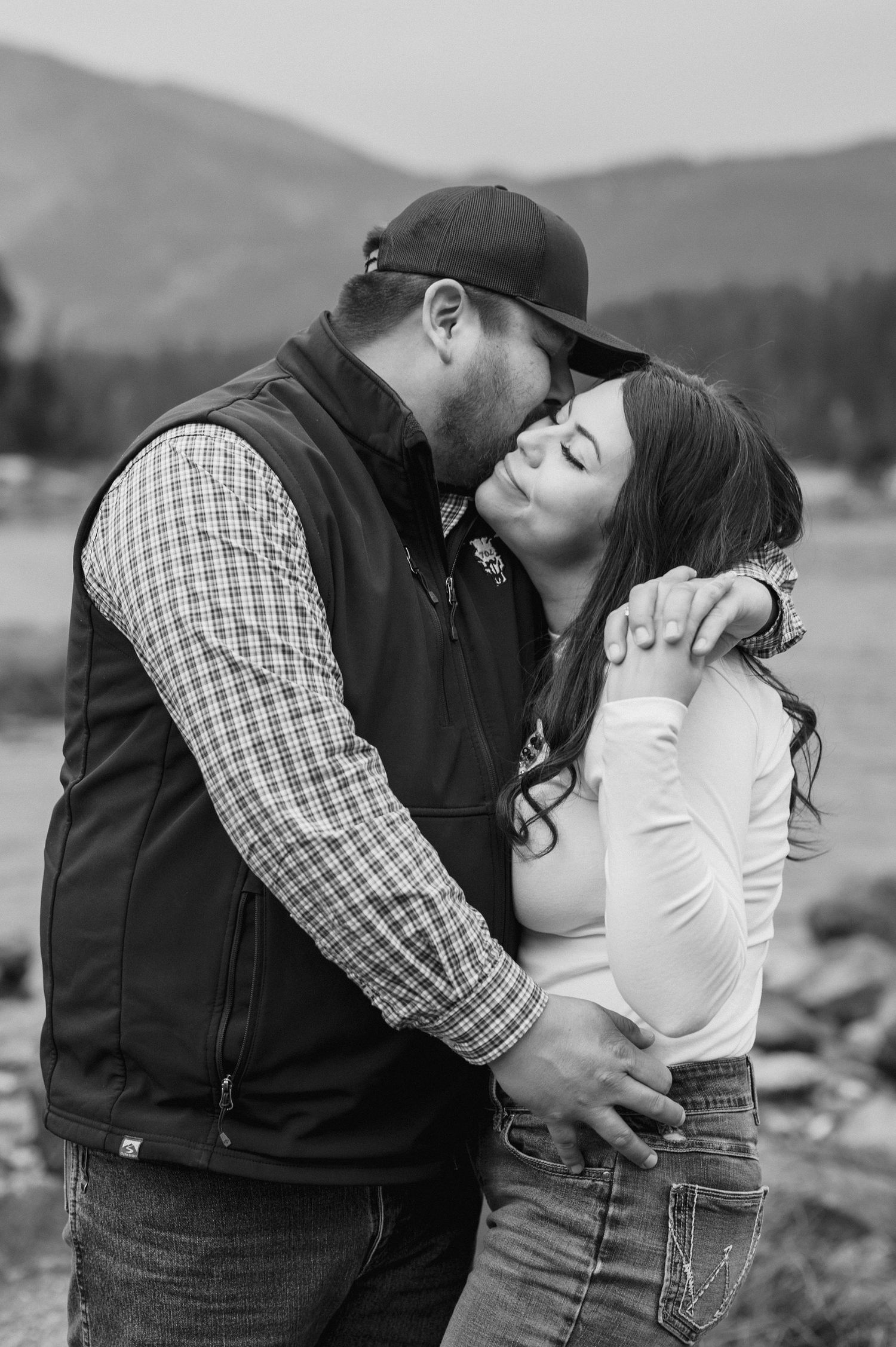 Cinematic lake engagement photos in the rain
