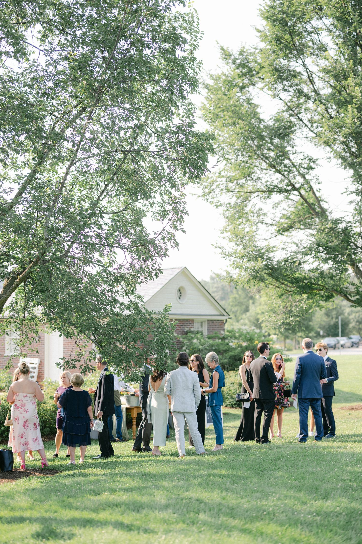 Elegant display of champagne glasses arranged in tiers on mirrored serving trays at an outdoor event. - Elawa Farm